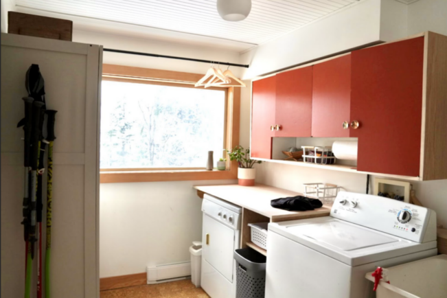 A clean laundry room with a properly vented dryer.