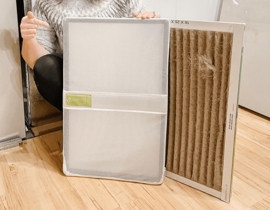 Person holding a Cycle Air filter for a furnace.