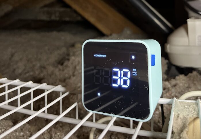 A small screen with a radon reading in a crawlspace that is used for Radon testing in the Kootenays.